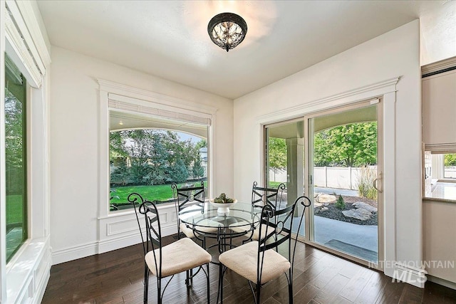 dining space featuring a healthy amount of sunlight and dark hardwood / wood-style floors