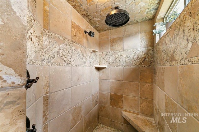 bathroom with tiled shower