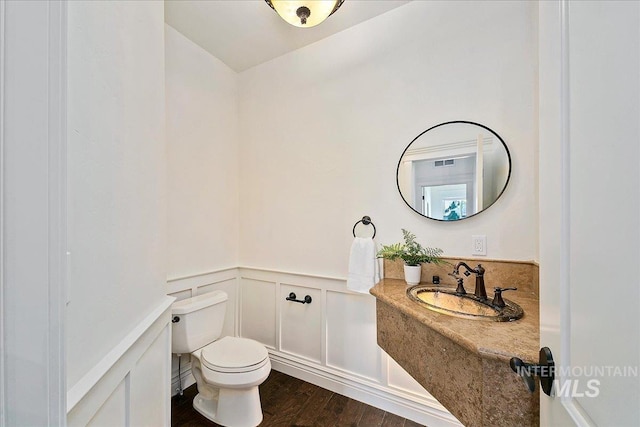 bathroom with sink, wood-type flooring, and toilet