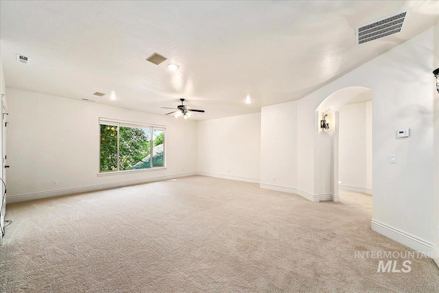 spare room with light colored carpet and ceiling fan