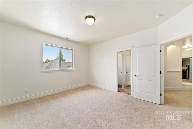 unfurnished bedroom with light carpet