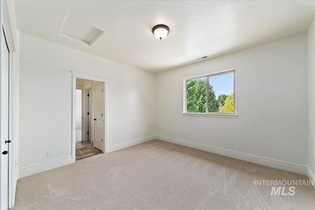 unfurnished room with light carpet