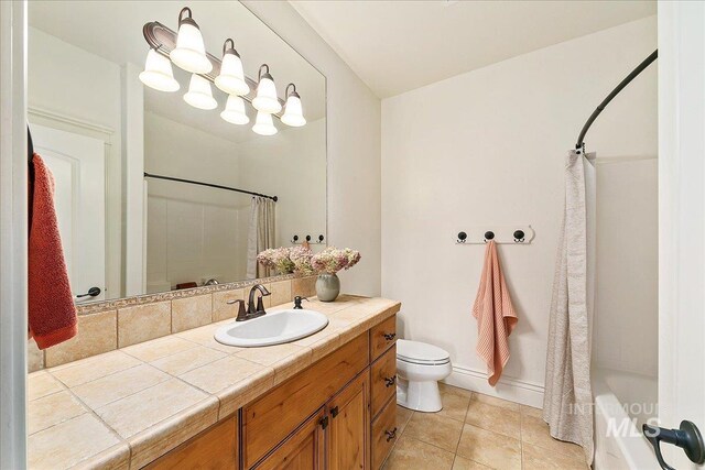 full bathroom featuring tile patterned floors, vanity, shower / tub combo, and toilet