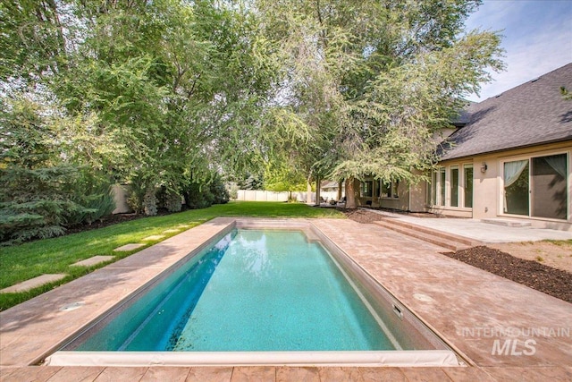 view of pool featuring a patio and a lawn