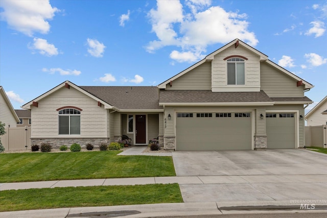 6413 E E Path, Nampa, ID 83687 - view of front of house featuring driveway, stone siding, roof with shingles, and an attached garage