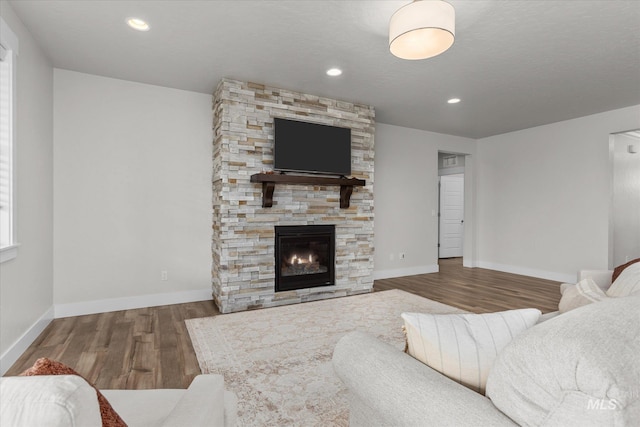6413 E E Path, Nampa, ID 83687 - living room featuring wood finished floors, baseboards, a fireplace, and recessed lighting