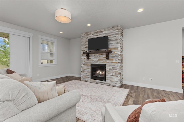 6413 E E Path, Nampa, ID 83687 - living area featuring plenty of natural light, baseboards, wood finished floors, a stone fireplace, and recessed lighting