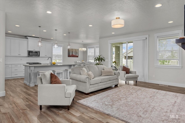 6413 E E Path, Nampa, ID 83687 - living area with healthy amount of natural light, light wood-style floors, recessed lighting, and a textured ceiling