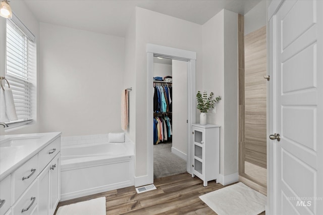 6413 E E Path, Nampa, ID 83687 - full bath with wood finished floors, tiled shower, a garden tub, vanity, and a walk in closet
