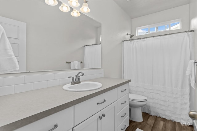 6413 E E Path, Nampa, ID 83687 - full bath with tasteful backsplash, wood finished floors, vanity, toilet, and curtained shower