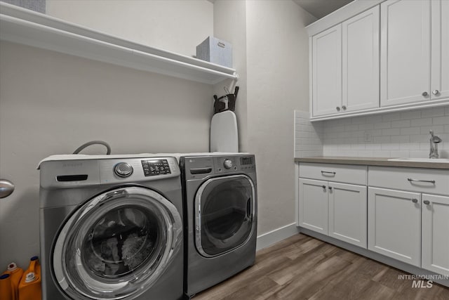 6413 E E Path, Nampa, ID 83687 - washroom with cabinet space, washer and dryer, wood finished floors, and baseboards