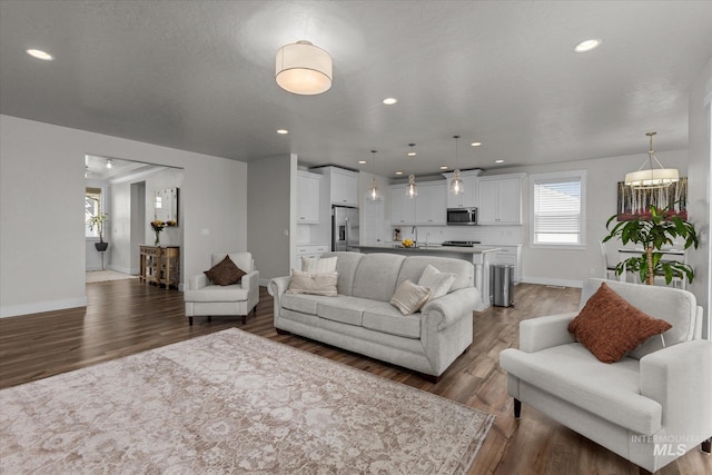 6413 E E Path, Nampa, ID 83687 - living room featuring plenty of natural light, wood finished floors, baseboards, and recessed lighting