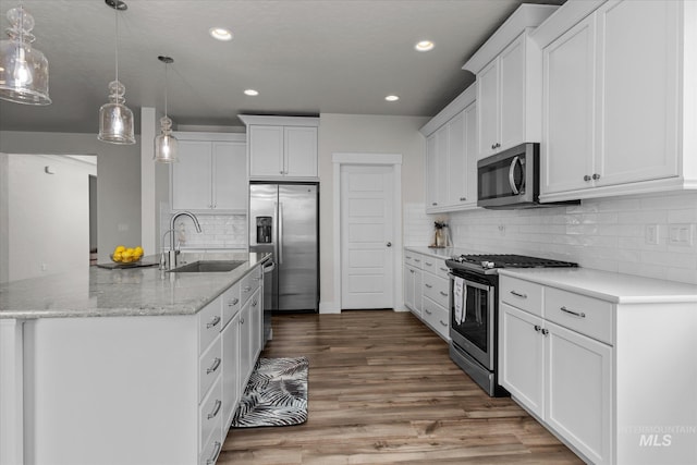 6413 E E Path, Nampa, ID 83687 - kitchen featuring stainless steel appliances, a sink, white cabinetry, recessed lighting, and light wood finished floors