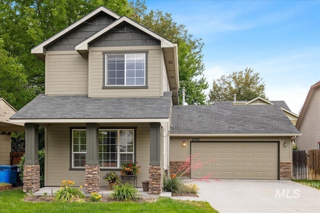 2972 N Saint James Pl, Boise, ID 83703 - craftsman house with covered porch, driveway, an attached garage, stone siding, and a shingled roof