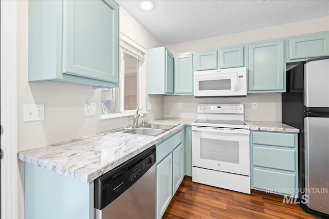 2972 N Saint James Pl, Boise, ID 83703 - kitchen featuring stainless steel appliances, blue cabinets, dark wood-style floors, light countertops, and recessed lighting