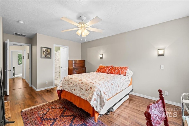 2972 N Saint James Pl, Boise, ID 83703 - bedroom with wood finished floors, a textured ceiling, a ceiling fan, and ensuite bathroom