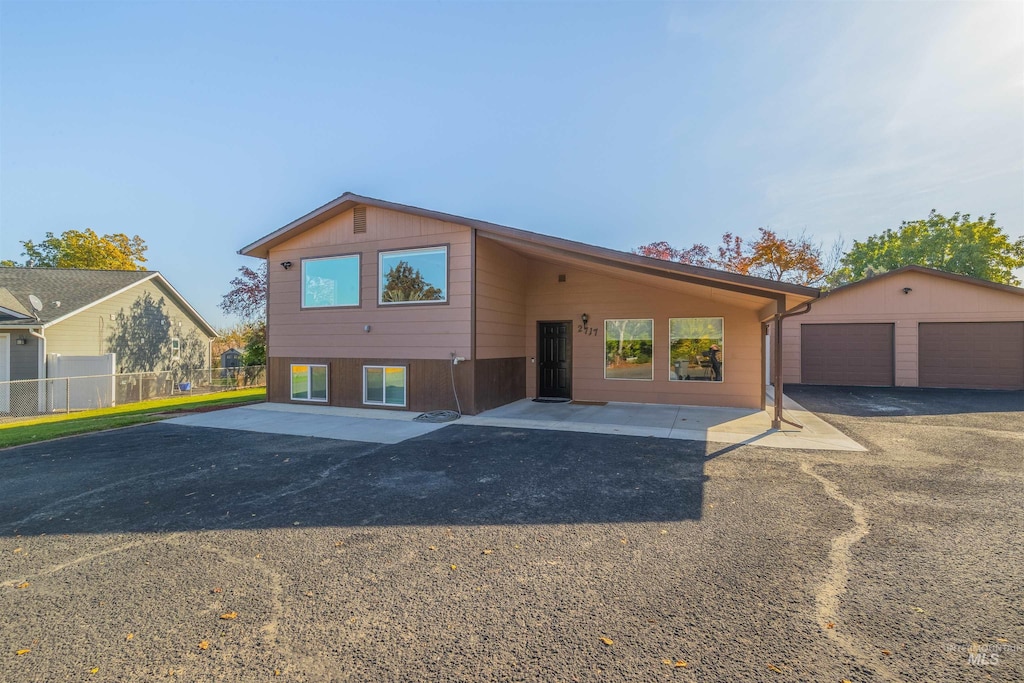 view of front of property with a garage and an outbuilding