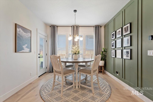 203 S Fusion Ave, Kuna, ID 83634 - dining area with a chandelier, plenty of natural light, baseboards, and light wood finished floors