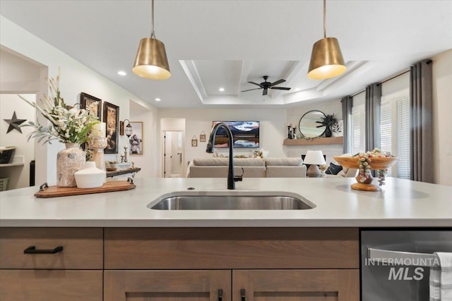 203 S Fusion Ave, Kuna, ID 83634 - kitchen featuring a sink, dishwasher, light countertops, open floor plan, and ceiling fan