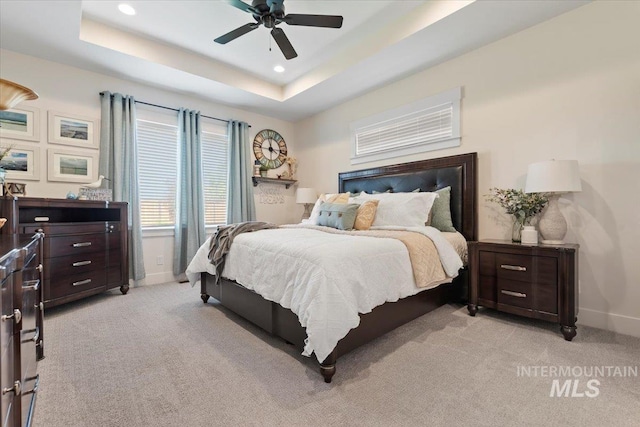 203 S Fusion Ave, Kuna, ID 83634 - bedroom with baseboards, light carpet, recessed lighting, a raised ceiling, and a ceiling fan