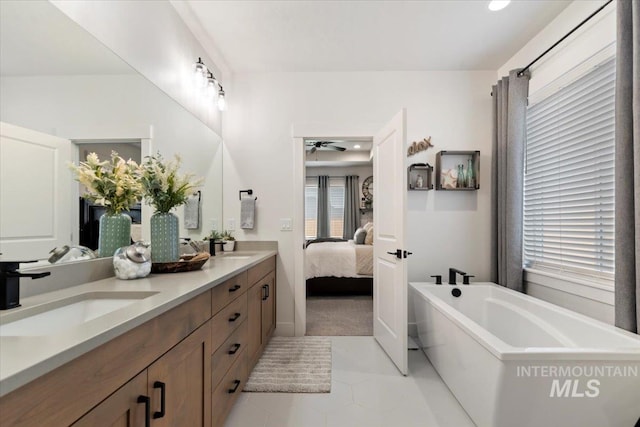 203 S Fusion Ave, Kuna, ID 83634 - full bath featuring ceiling fan, a freestanding tub, ensuite bath, double vanity, and tile patterned flooring