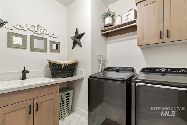 203 S Fusion Ave, Kuna, ID 83634 - laundry room featuring separate washer and dryer, light marble finish flooring, and cabinet space