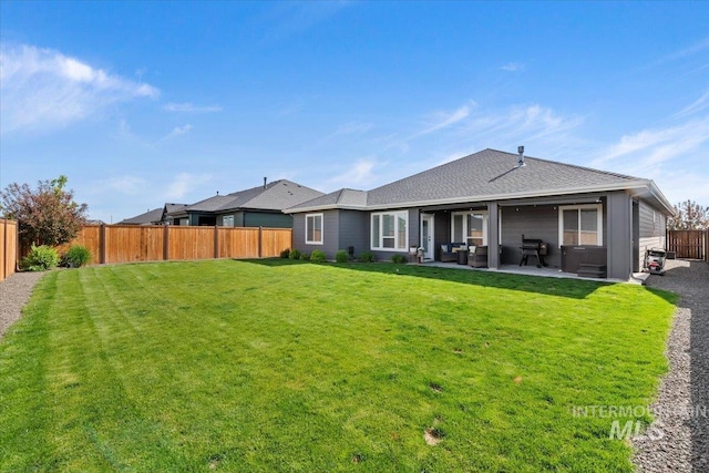 203 S Fusion Ave, Kuna, ID 83634 - rear view of house with a patio and a shingled roof