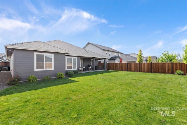 203 S Fusion Ave, Kuna, ID 83634 - rear view of property with a patio area, roof with shingles, and central air condition unit