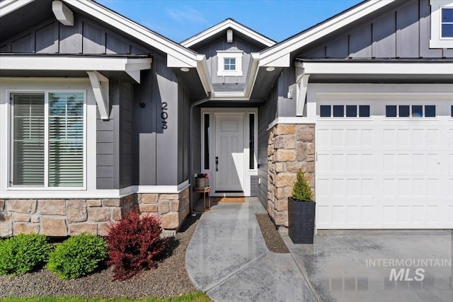 203 S Fusion Ave, Kuna, ID 83634 - doorway to property featuring stone siding, board and batten siding, and a garage