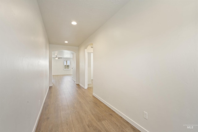 10663 W Catmint, Star, ID 83669 - hallway with baseboards, arched walkways, recessed lighting, and light wood finished floors