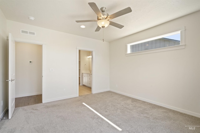 10663 W Catmint, Star, ID 83669 - unfurnished bedroom with light carpet, baseboards, ensuite bath, and a ceiling fan