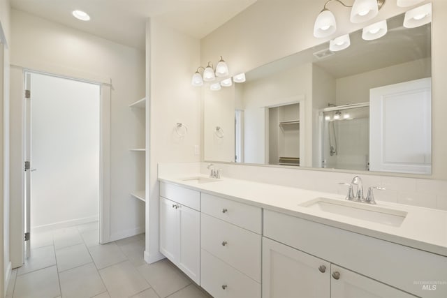 10663 W Catmint, Star, ID 83669 - full bath with a spacious closet, a stall shower, double vanity, tile patterned flooring, and baseboards