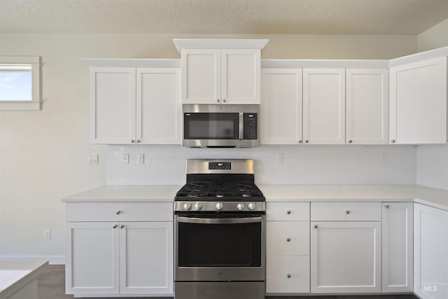 10663 W Catmint, Star, ID 83669 - kitchen featuring appliances with stainless steel finishes, tasteful backsplash, white cabinetry, and a textured ceiling