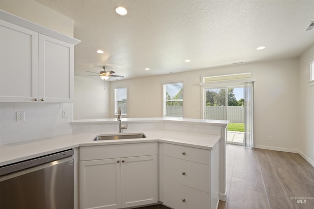 10663 W Catmint, Star, ID 83669 - kitchen featuring dishwasher, a sink, a peninsula, white cabinetry, and light countertops