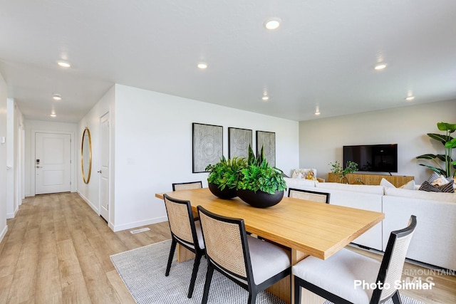 dining room featuring light wood finished floors, recessed lighting, and baseboards