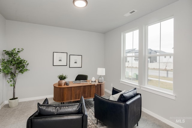 home office with baseboards, plenty of natural light, visible vents, and carpet flooring