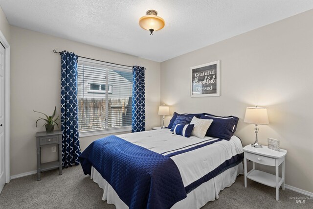 carpeted bedroom featuring baseboards