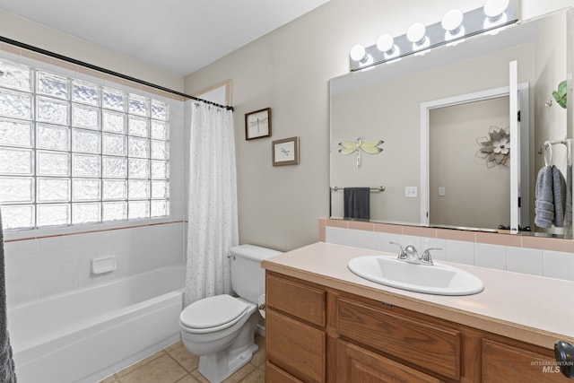 bathroom featuring toilet, tile patterned floors, shower / bath combo, and vanity