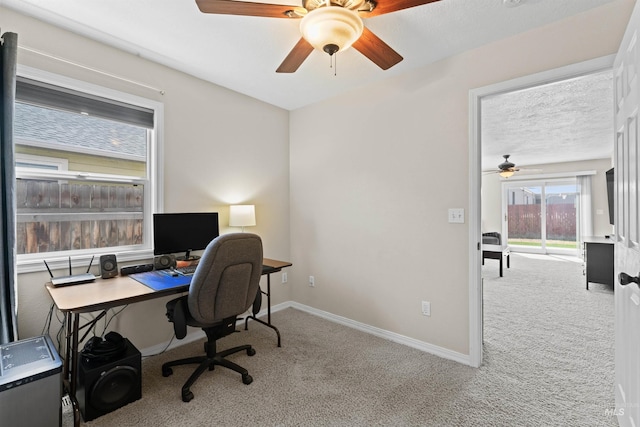 office space with carpet flooring, ceiling fan, and baseboards