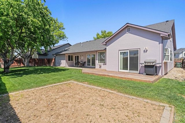 back of property featuring a wooden deck and roof with shingles