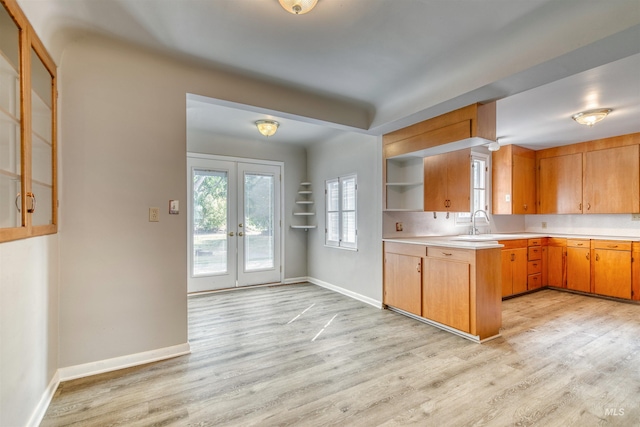 kitchen with french doors, light hardwood / wood-style floors, and sink