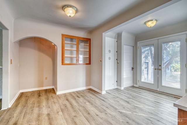 foyer entrance featuring light hardwood / wood-style flooring and french doors