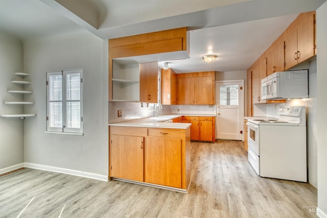 kitchen featuring white appliances, tasteful backsplash, light hardwood / wood-style flooring, and sink