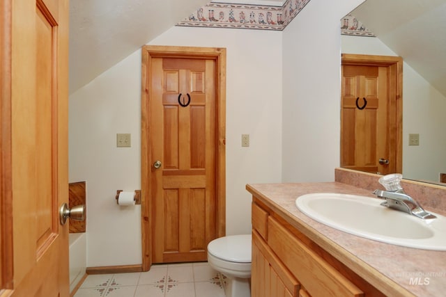 351 Estate Dr, Cascade, ID 83611 - half bath featuring vaulted ceiling, toilet, tile patterned flooring, and vanity