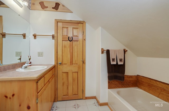 351 Estate Dr, Cascade, ID 83611 - full bath with lofted ceiling, vanity, a bath, and tile patterned flooring