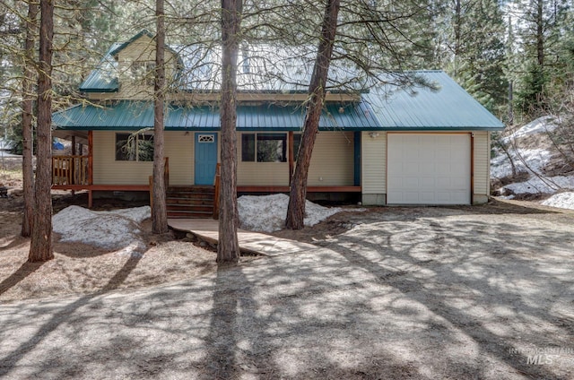 351 Estate Dr, Cascade, ID 83611 - view of front of property with metal roof, a garage, and covered porch