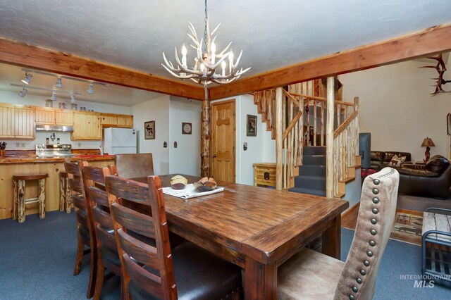 351 Estate Dr, Cascade, ID 83611 - dining room featuring a chandelier, stairs, and carpet floors