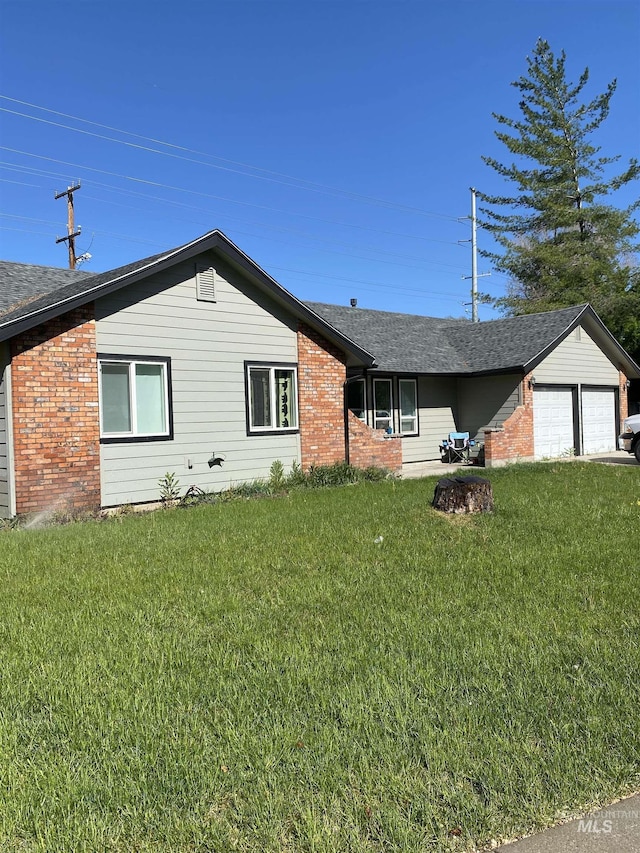 ranch-style house with brick siding, a front lawn, an attached garage, and a shingled roof