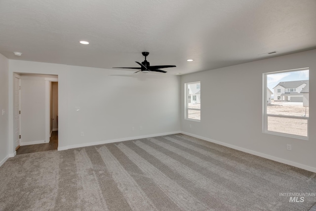 unfurnished room with baseboards, ceiling fan, recessed lighting, and light colored carpet