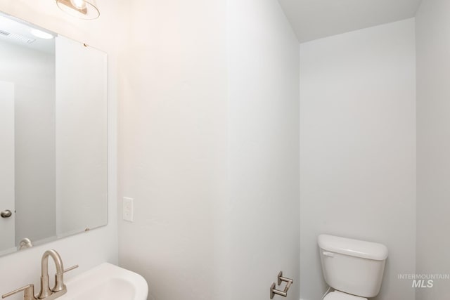 bathroom with visible vents, a sink, and toilet